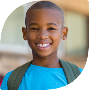 Young boy wearing backpack and smiling