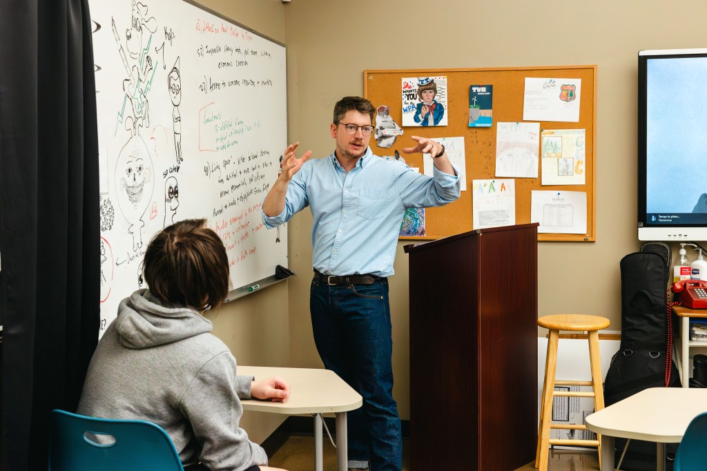 NewHope Academy teacher leading classroom instruction while students participate