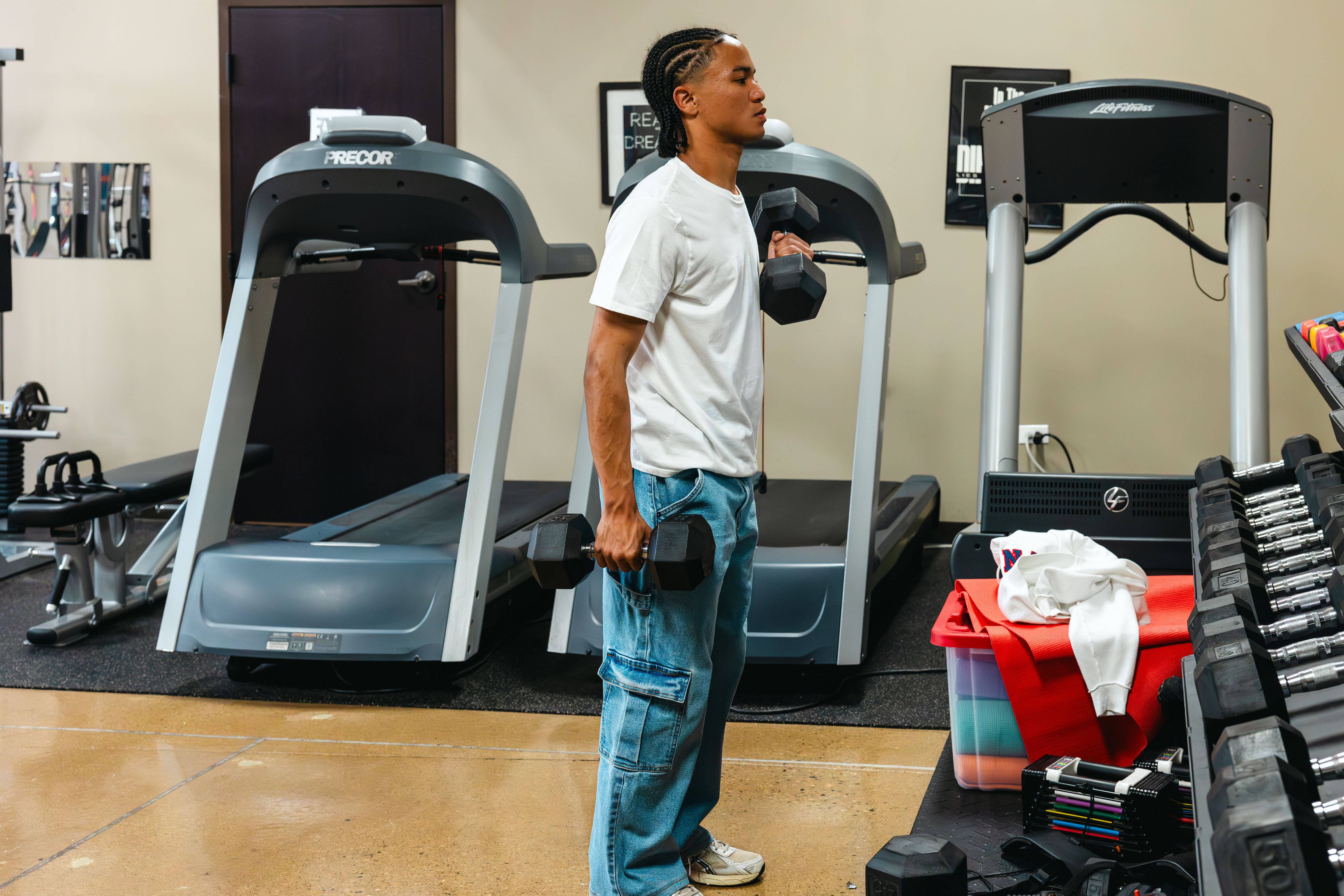 NewHope Academy student holds dumbbells during a fitness and physical education activity.