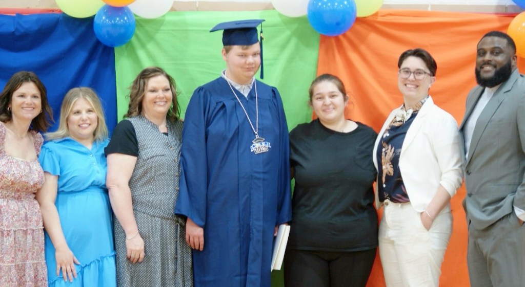 Students posing with staff at High Road School Marion County graduation