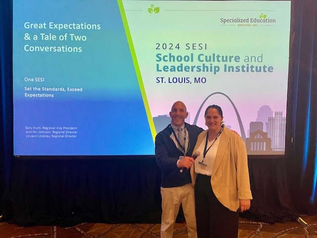 Veteran educator Vincent Lindsley with colleague at leadership conference