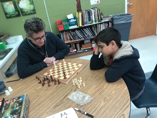 The Auburn School student playing chess with veteran teacher Paris Thalheimer