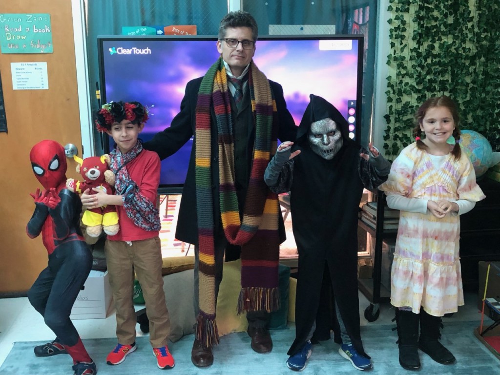 Classroom of students posing in costumes with veteran teacher Paris Thalheimer