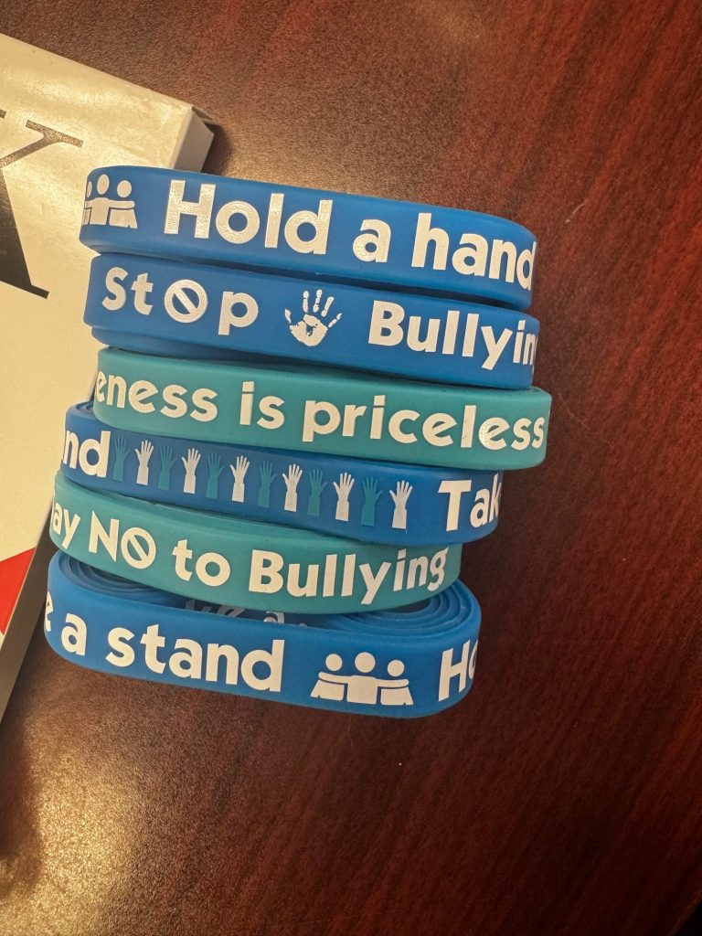 Excel students wearing “Say No to Bullying” wristbands - daily kindness reminder - Excel bullying prevention