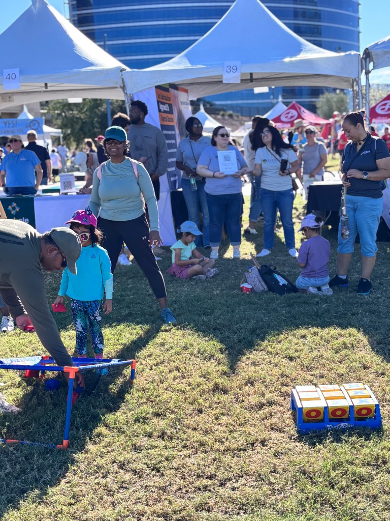Sierra Schools of Arizona attendees playing corn hole at YES Day Walk for Autism resource fair
