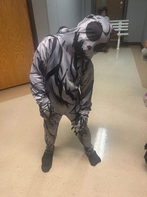 Student in full-body Halloween costume posing in the hallway