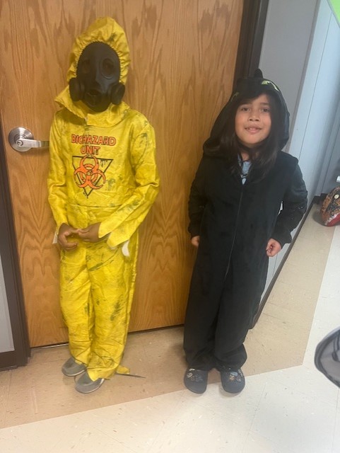 Students dressed as a biohazard character and cartoon figure enjoying the event