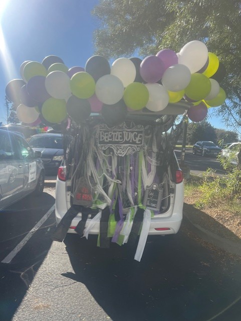 Beetlejuice-themed trunk decorated with balloons and webs