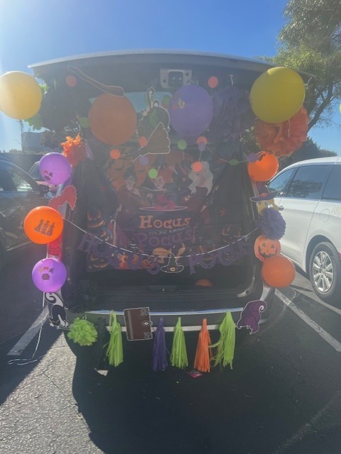 Hocus Pocus-themed trunk with balloons and Halloween decorations