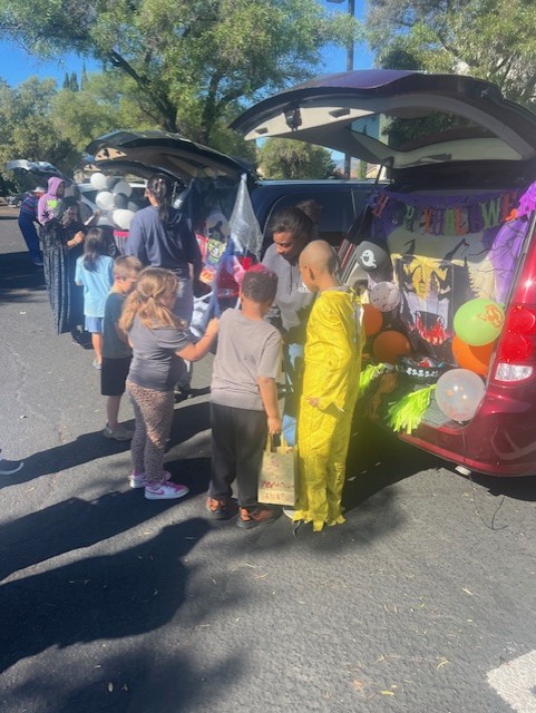 Students collecting candy at decorated trunks during the festival