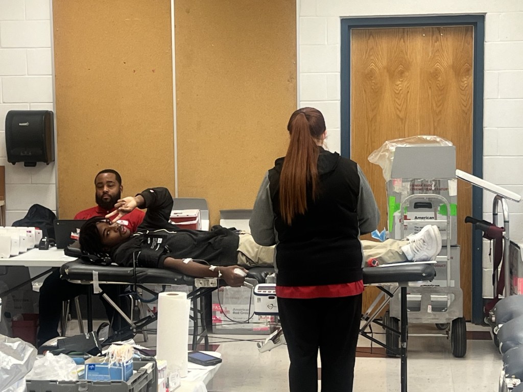 Excel Academy Central students and staff donating blood during community event