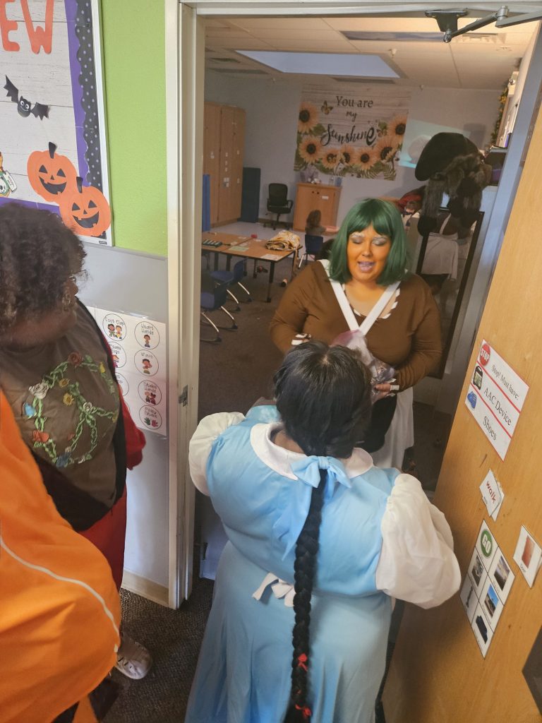 Students in costumes at Lattice Fall Festival 2025 alongside staff dressed as an Oompa Loompa.