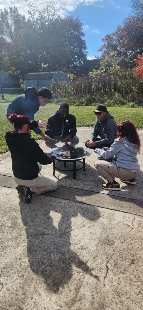 Students roasting marshmallows for s’mores at High Road School of York.