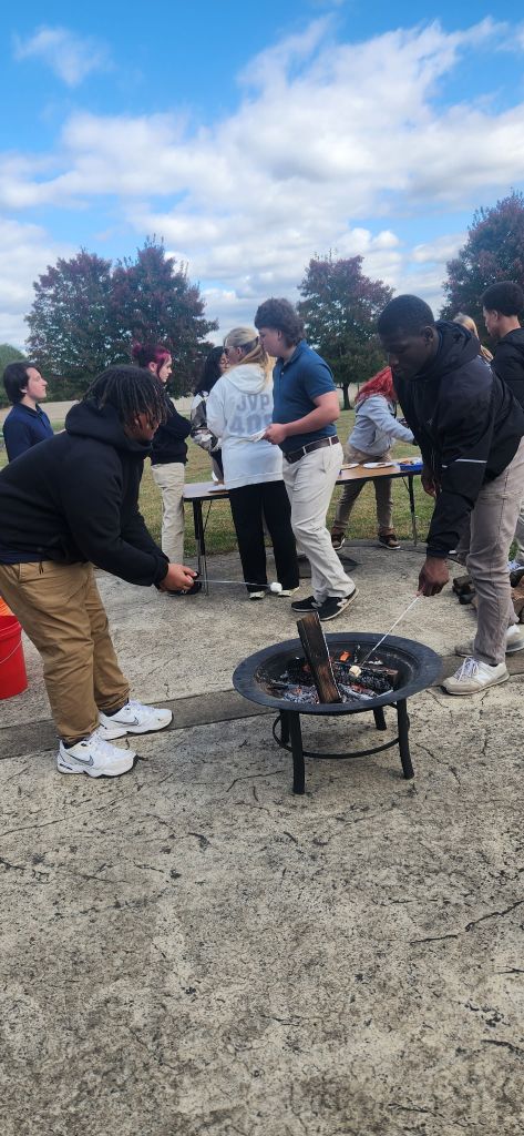 Students roasting marshmallows for s’mores at High Road School of York.