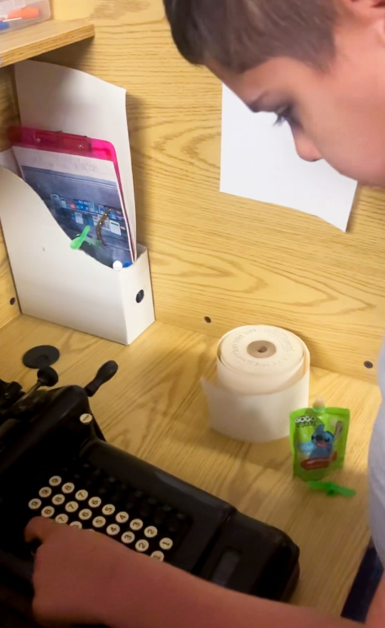 High Road School of Darien student Noah examining antique adding machine