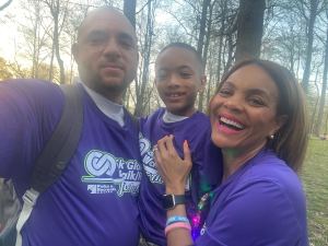 Tallen's family at an Autism awareness walk, smiling in matching shirts