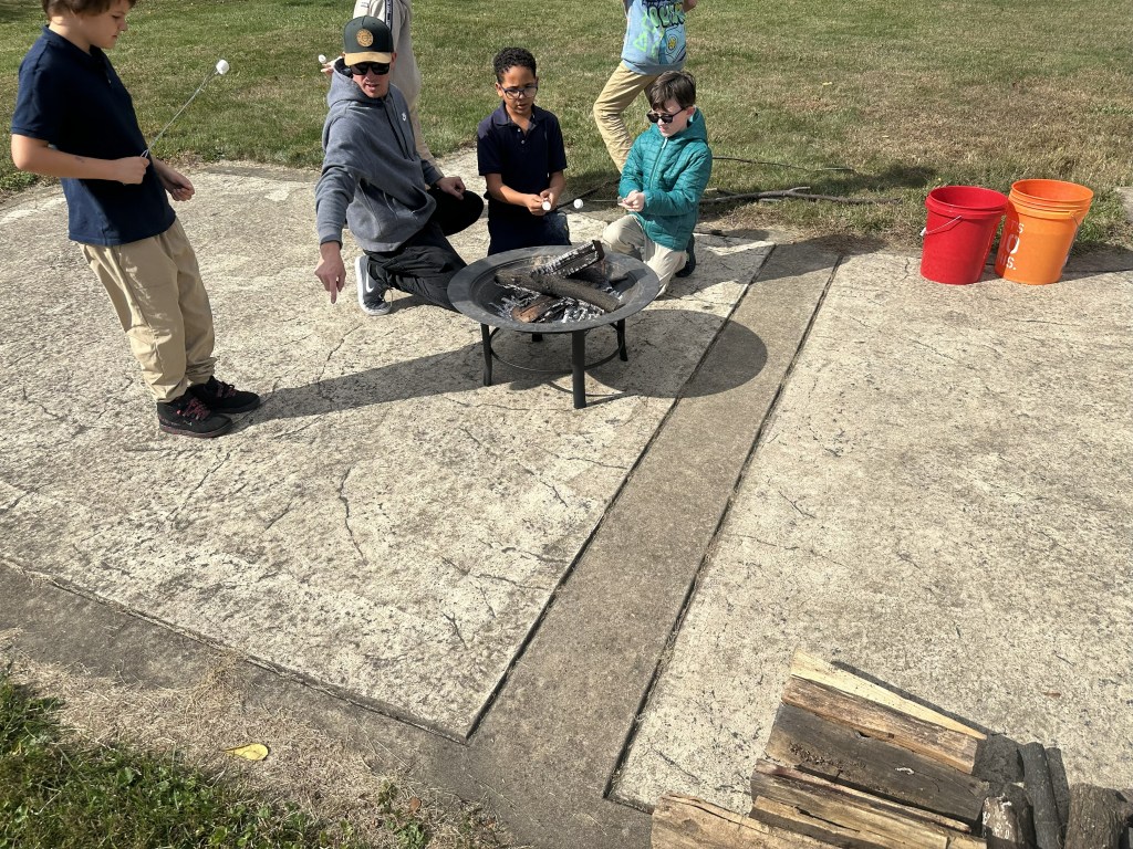 Students roasting marshmallows for s’mores at High Road School of York.