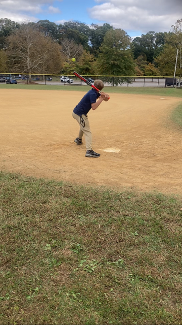 DJ swinging at a baseball pitch as part of his reward system at High Road School