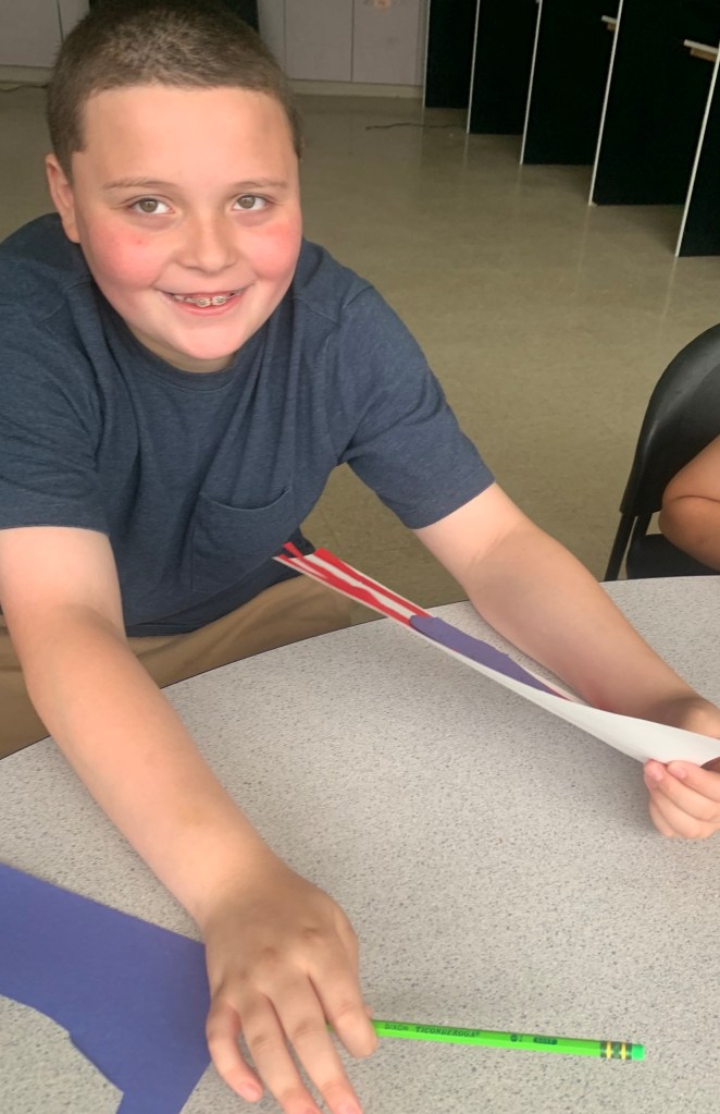 Aiden working on an art project while building skills at High Road School