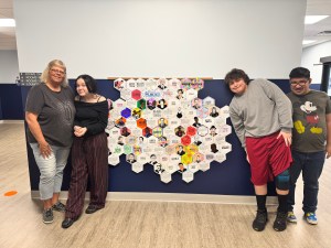 Students and staff presenting a Black history honeycomb collage at High Road School of Marion County