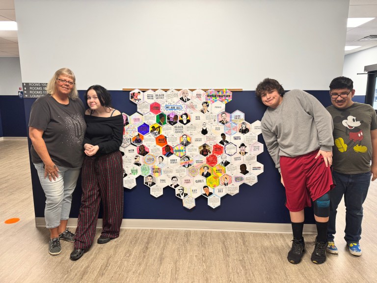 Students and staff presenting a Black history honeycomb collage at High Road School of Marion County