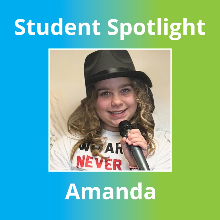 Amanda smiling while speaking into a microphone at Sierra School at Wylie