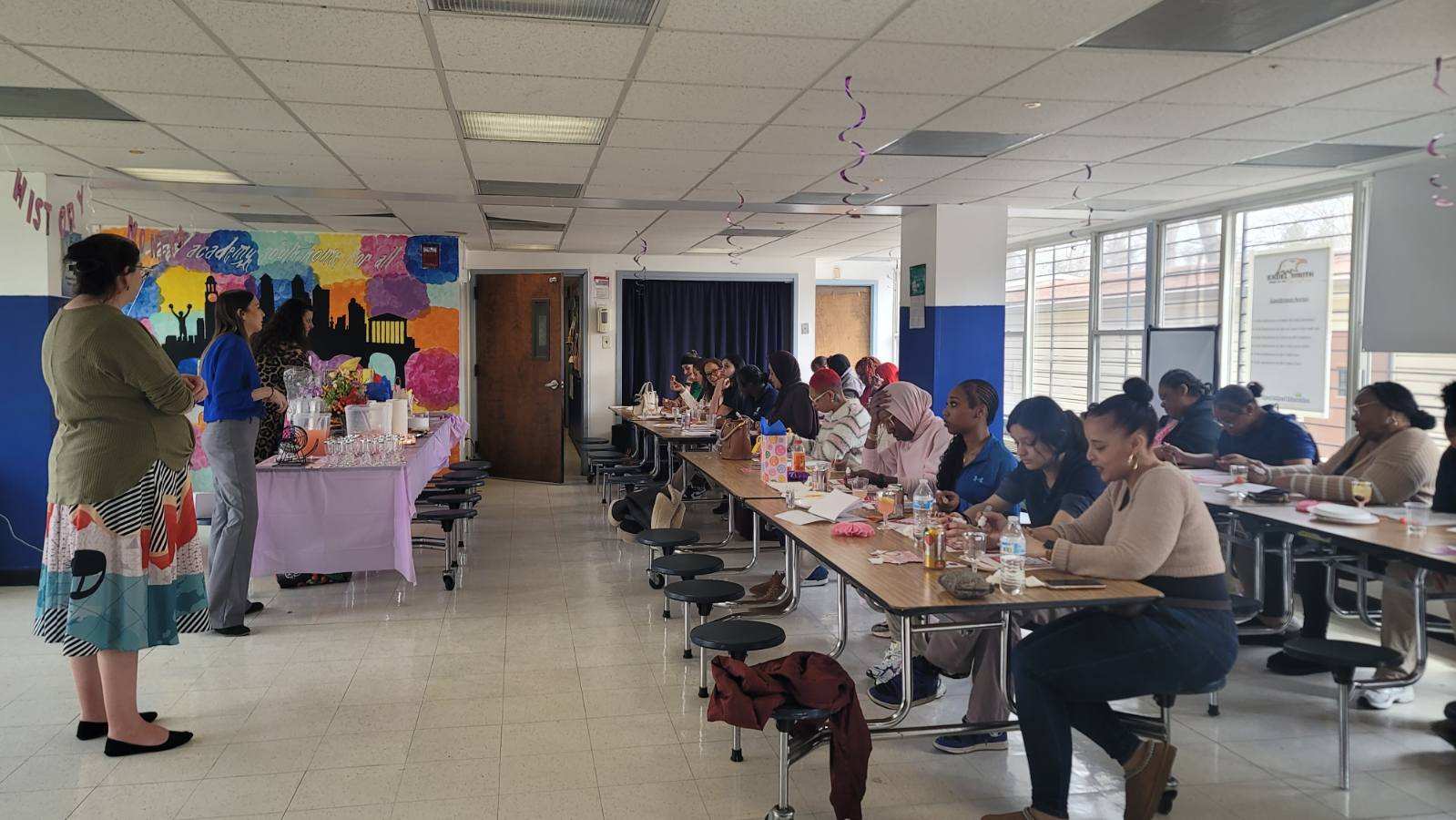 Students and families playing bingo at Excel Academy South event