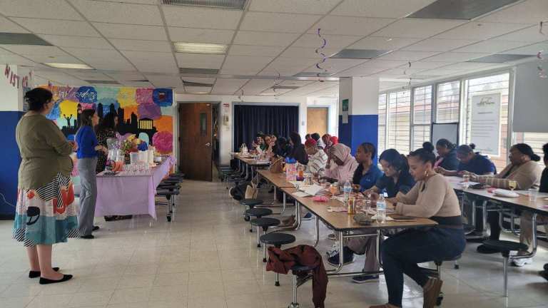 Students and families playing bingo at Excel Academy South event