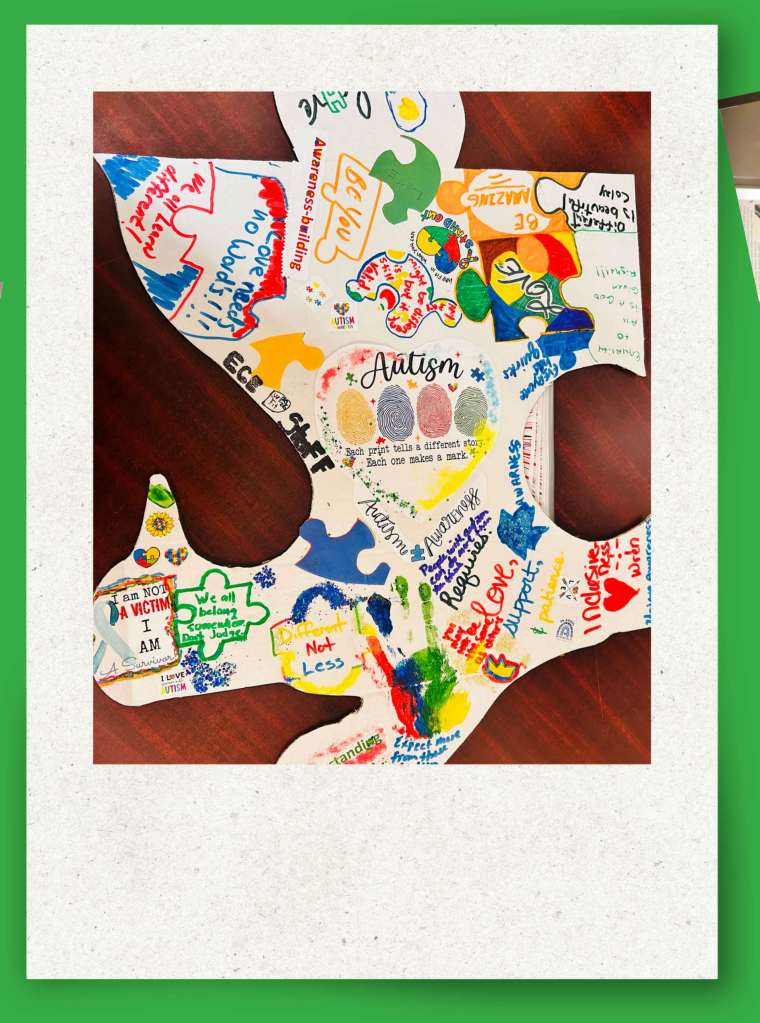 Student art display featuring puzzle pieces for Autism Awareness Month