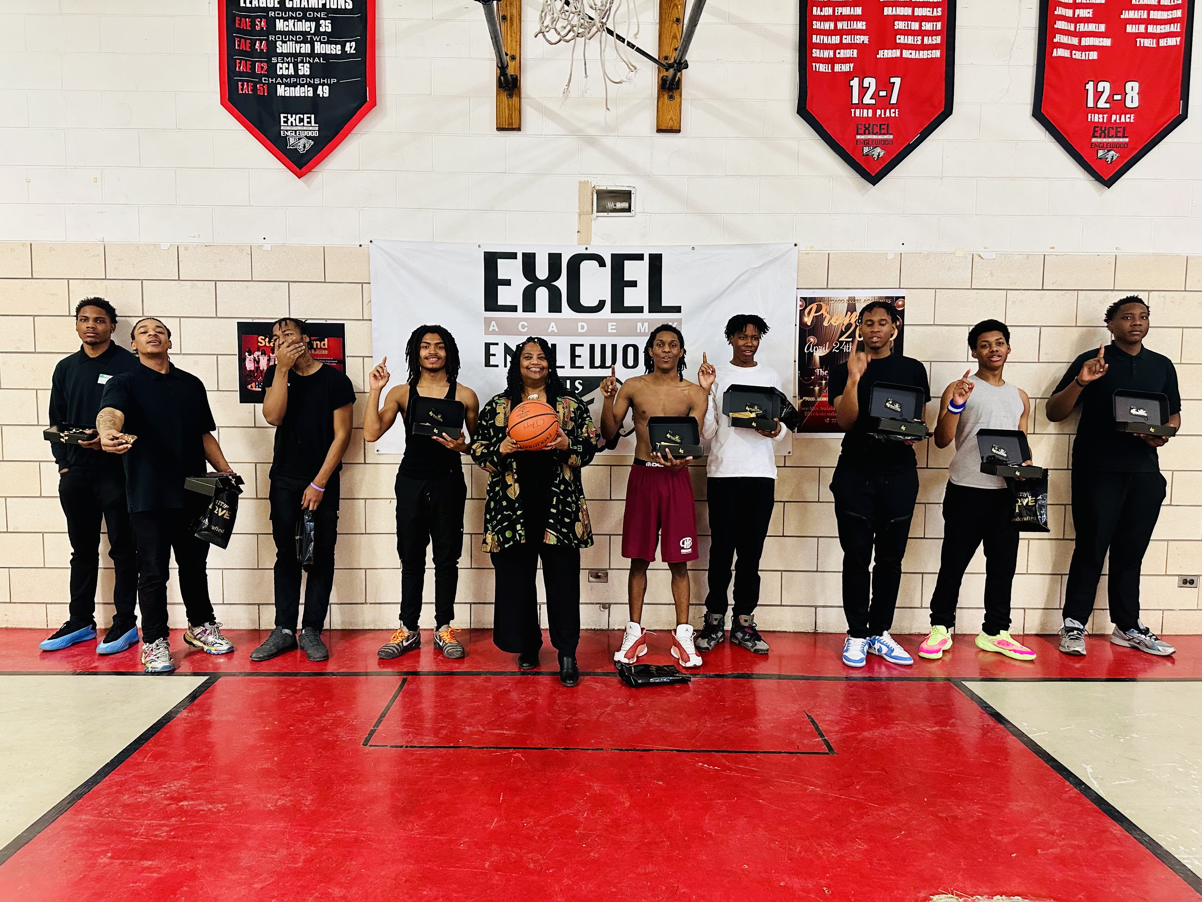 Students stand in a line on the basketball court at Excel Academy of Englewood gym