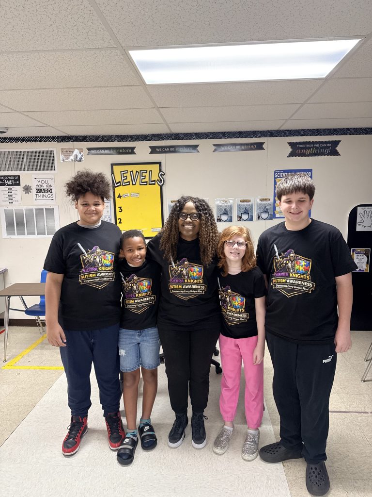 Group photo of students and staff during Autism Awareness tailgate