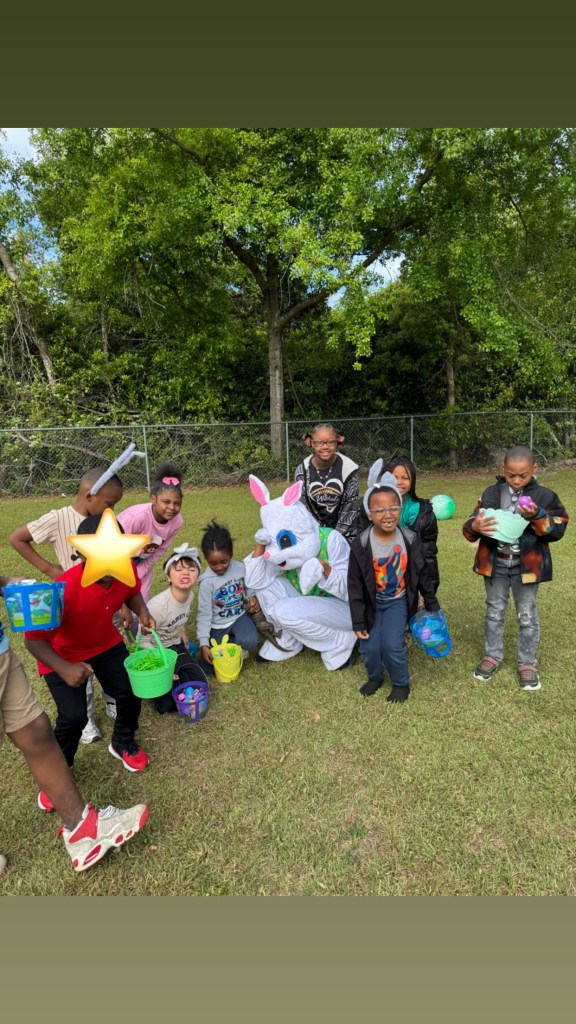Group of students with buckets and Easter Bunny during school event