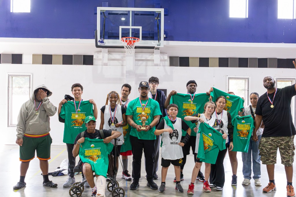 Sierra Schools teams and staff pose together on the court celebrating their participation in the March Madness tournament