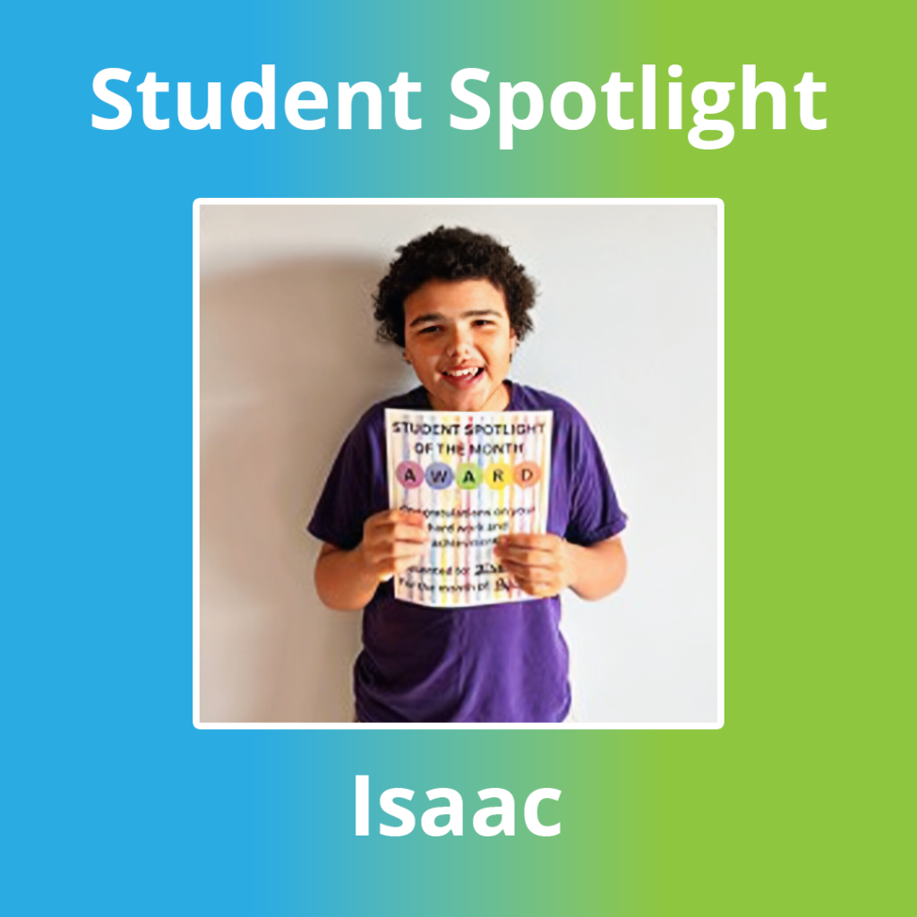 Student Isaac holding a student spotlight award in the classroom
