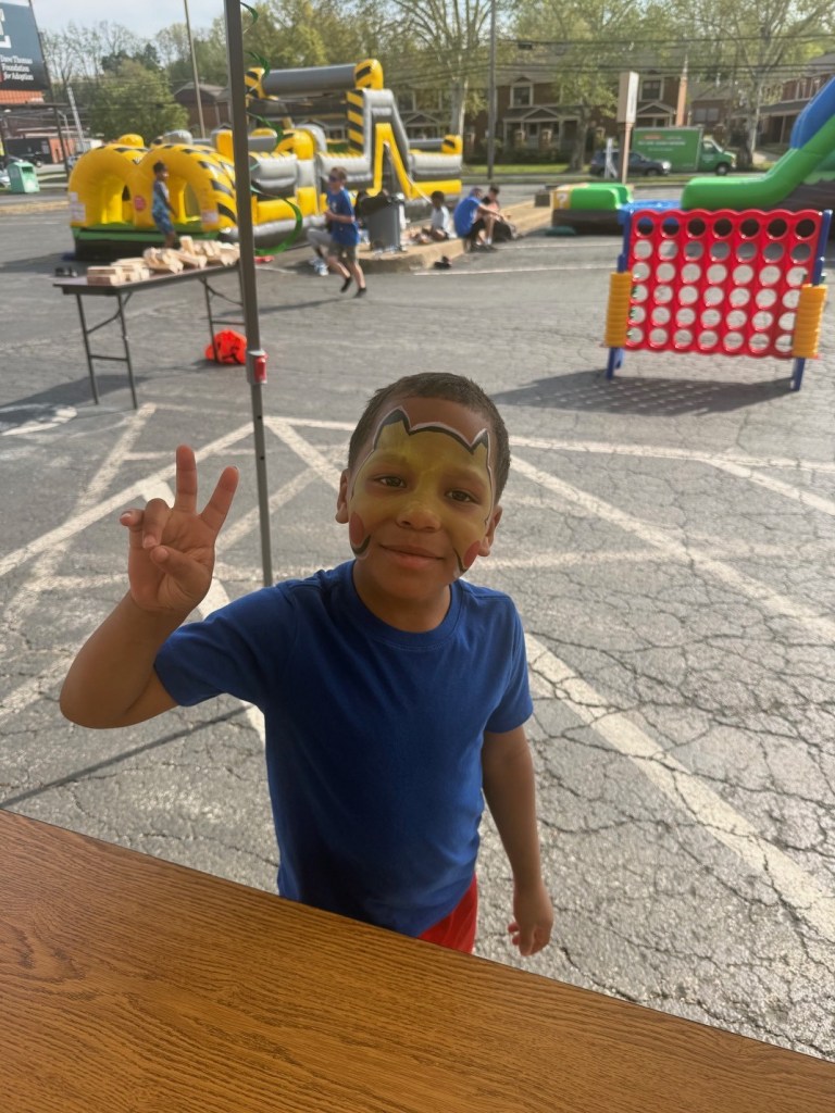 Student getting face paint at school event