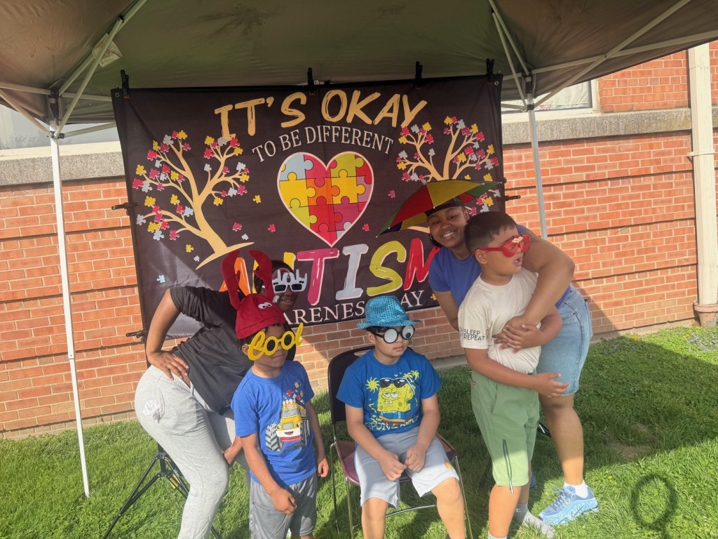 Students posing with props at photo booth