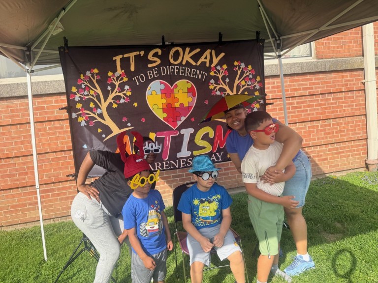 Students posing with props at photo booth