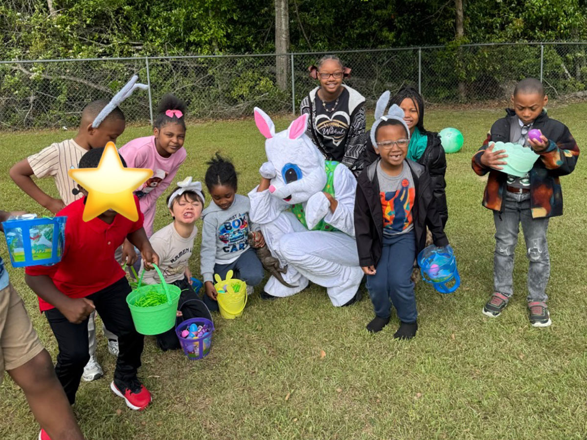 Group of students with buckets and Easter Bunny during school event 2