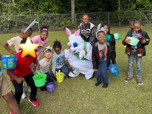 Group of students with buckets and Easter Bunny during school event 2