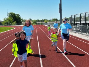 High Road staff and students running together during Field Day relay races