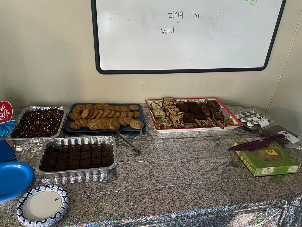 Dessert table featuring brownies, cookies, pie, cupcakes and assorted sweet treats for staff appreciation activities.