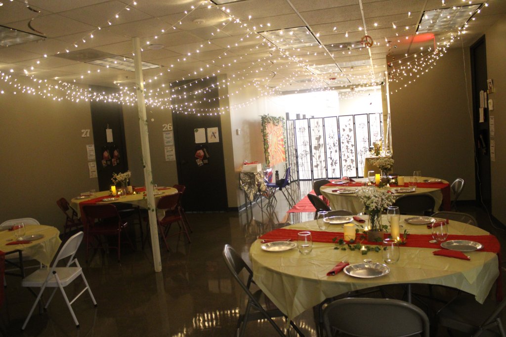 Wide view of decorated prom tables, hanging lights and candles during the NewHope Academy prom event.
