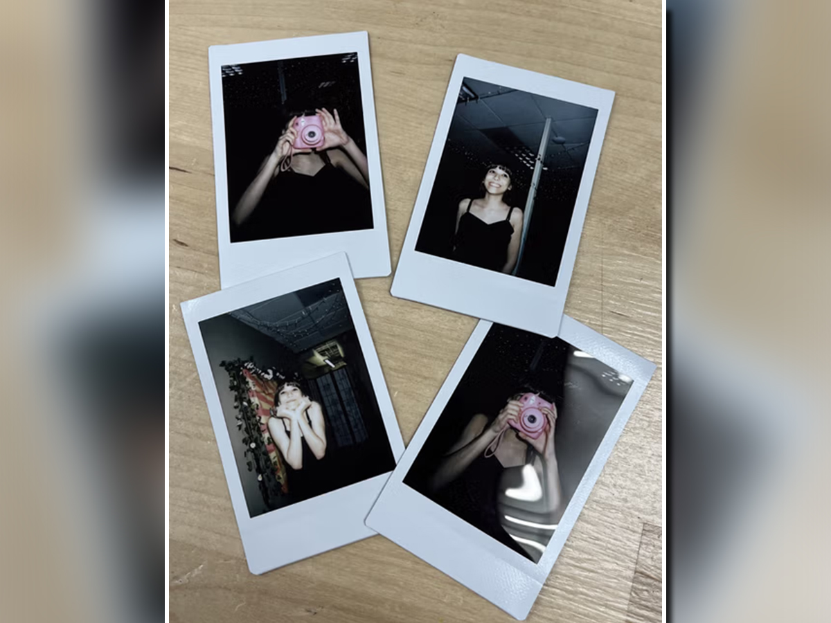 Polaroid photos displayed on a table featuring students enjoying prom night at NewHope Academy.