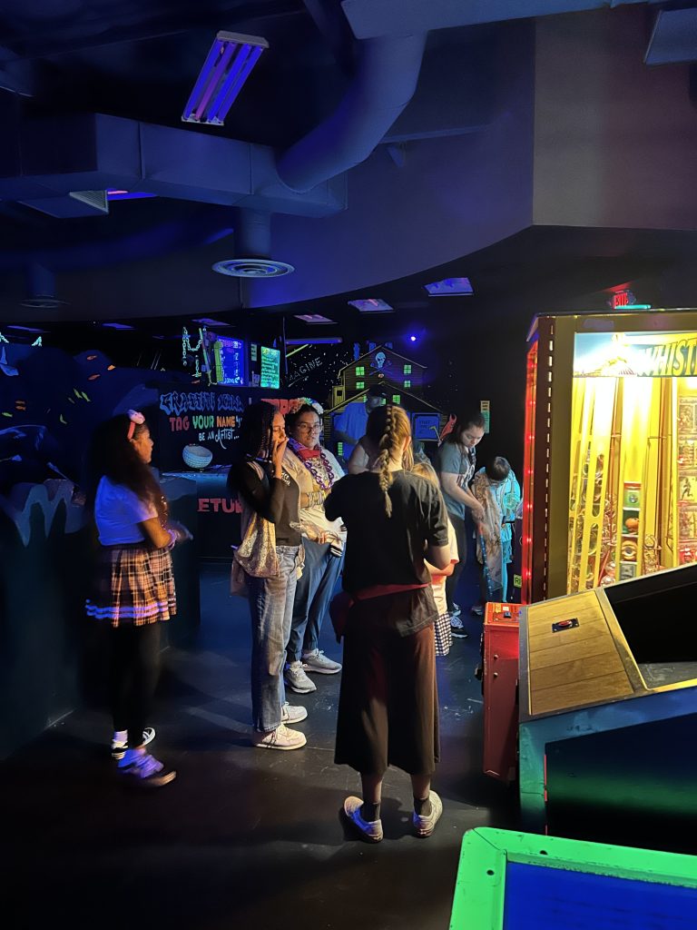 Sierra students and staff gathered inside arcade area during Fun Friday reward trip at 3D Mini Golf.