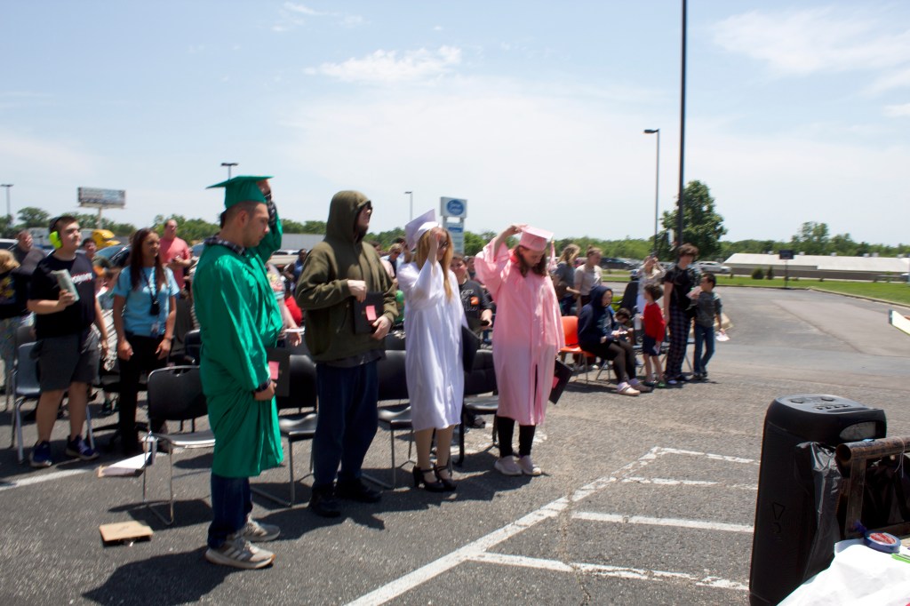 Graduates tossing caps in the air to celebrate graduation at High Road School of Wright City