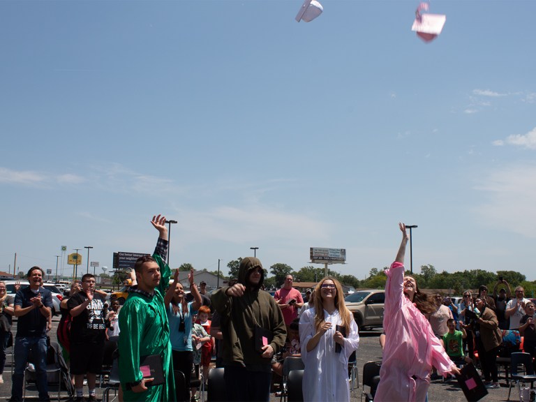 Graduates tossing caps in the air to celebrate graduation at High Road School of Wright City