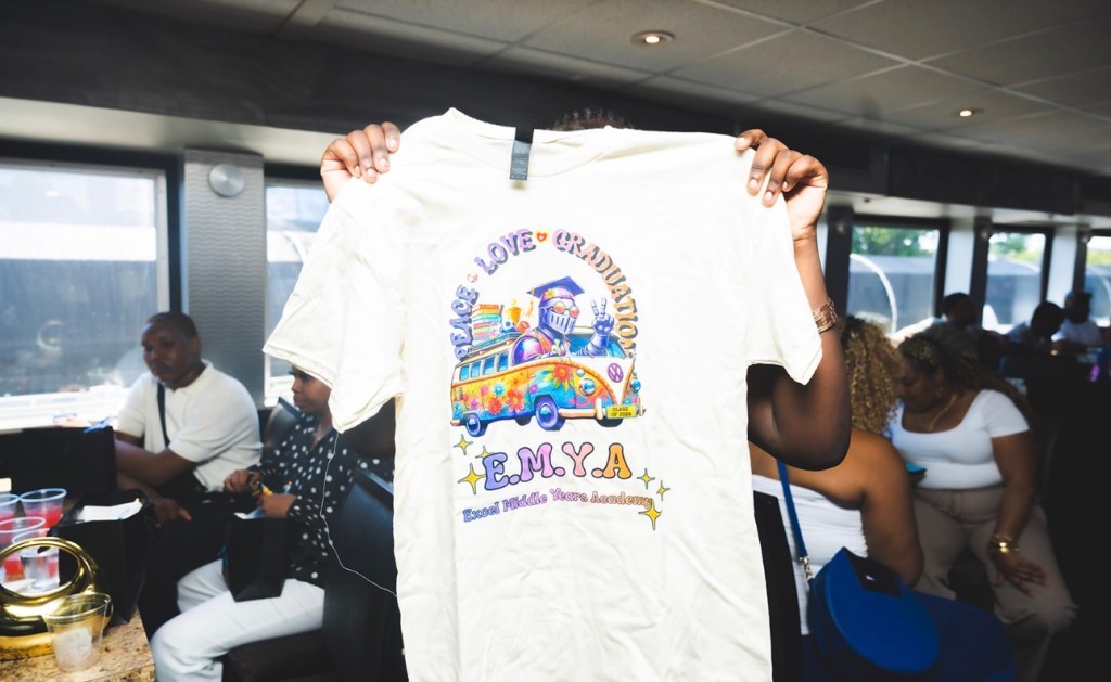 Custom Excel Middle Years Academy graduation shirt displayed during the luncheon event.