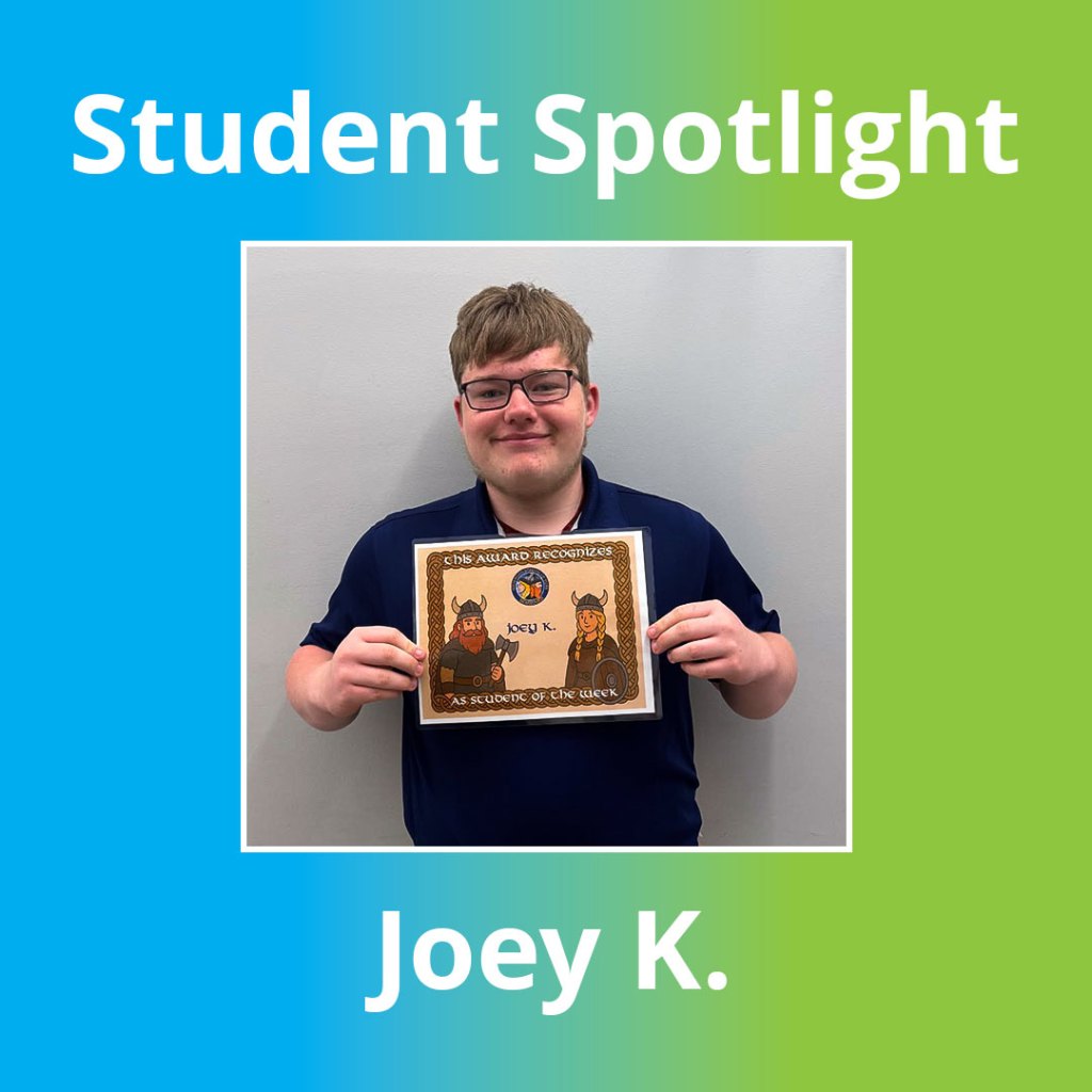 High school student holding a certificate of achievement while posing for a student spotlights photo at High Road School of York.