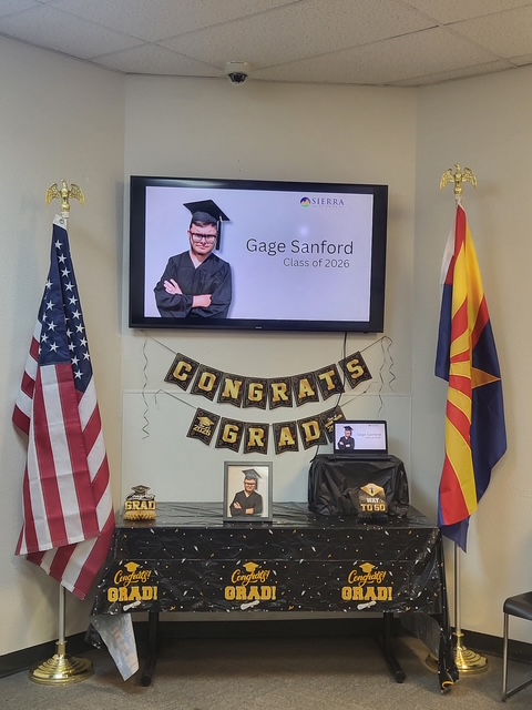 A graduation display honoring Gage Sanford, Class of 2026, is featured at Sierra School of Gilbert with photos, decorations and congratulatory signage.