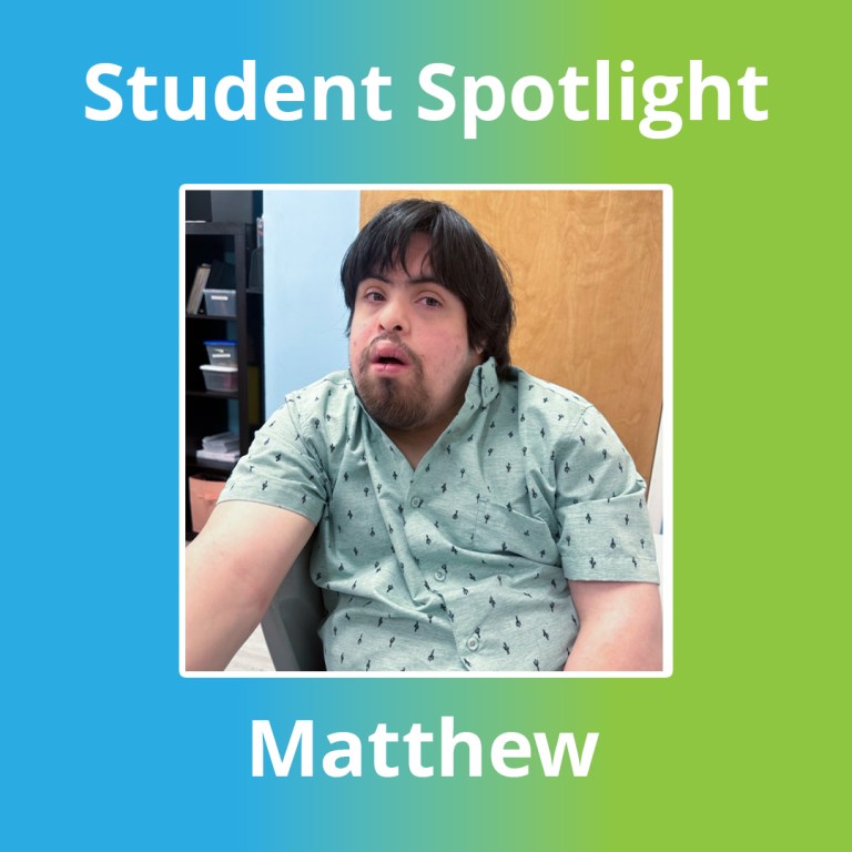 Matthew seated at a table in a patterned green shirt at BEST Academy.